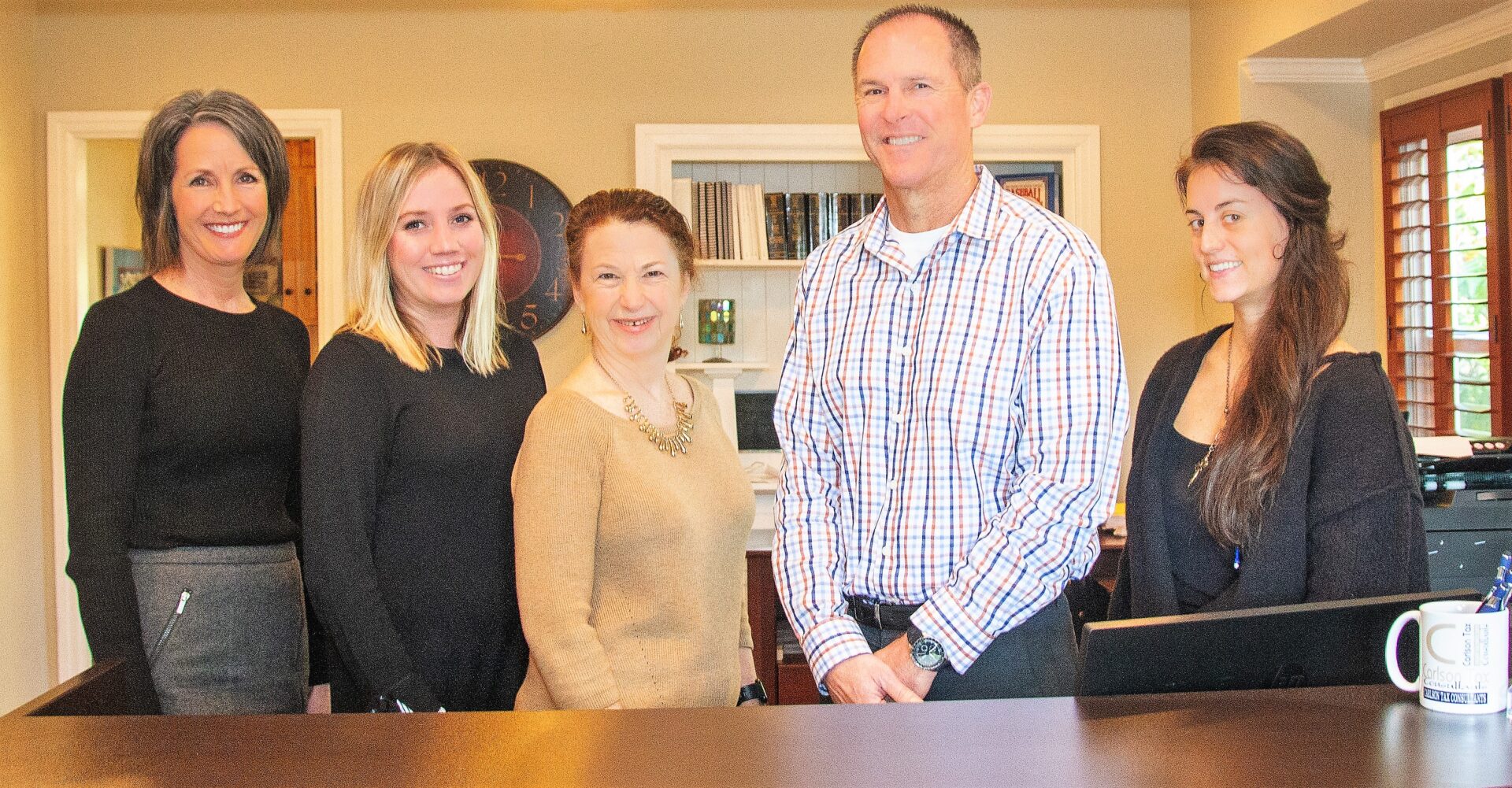 The Carlson Tax Consultants team behind the front desk of their Roseville office