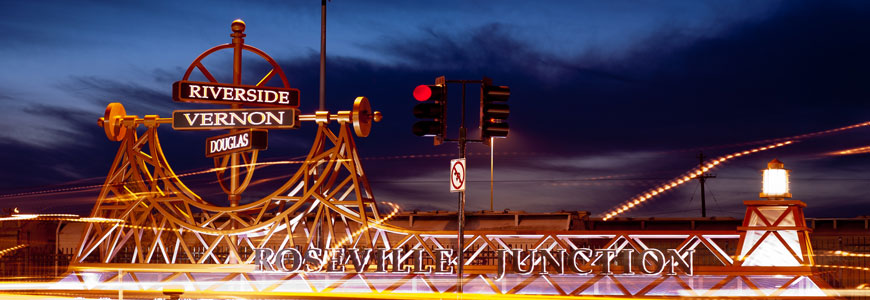 The Roseville Junction sign lit at dusk in downtown Roseville
